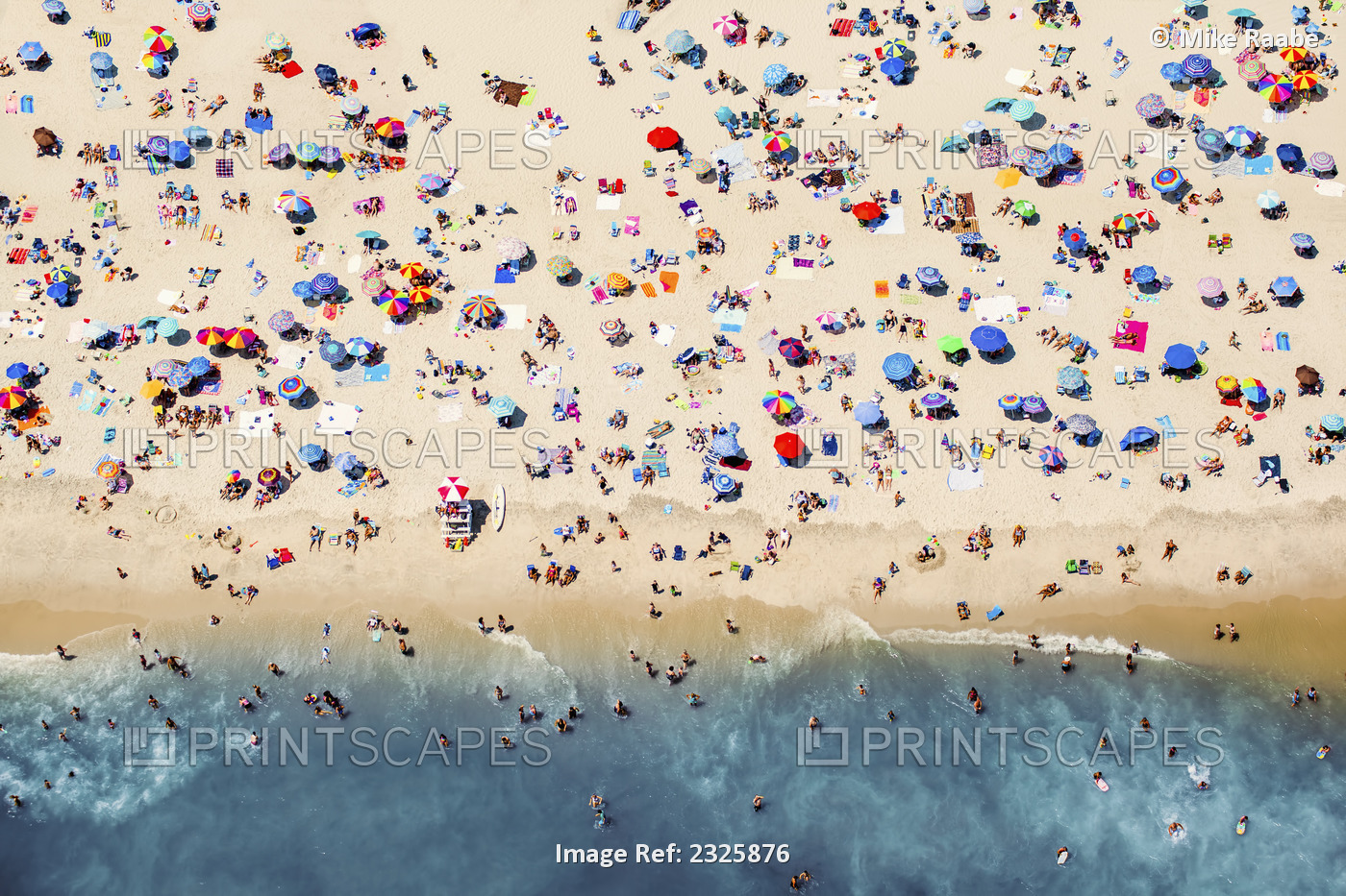 Aerial View Of A Busy Beach With A Colourful Assortment Of Umbrellas And Towels