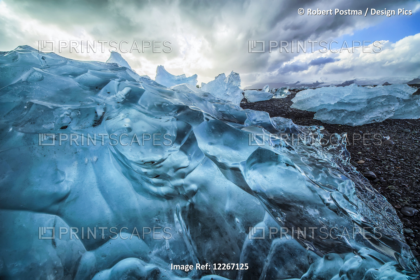 Along The South Shore Of Iceland, Large Chunks Of Ice Litter The Beach After ...