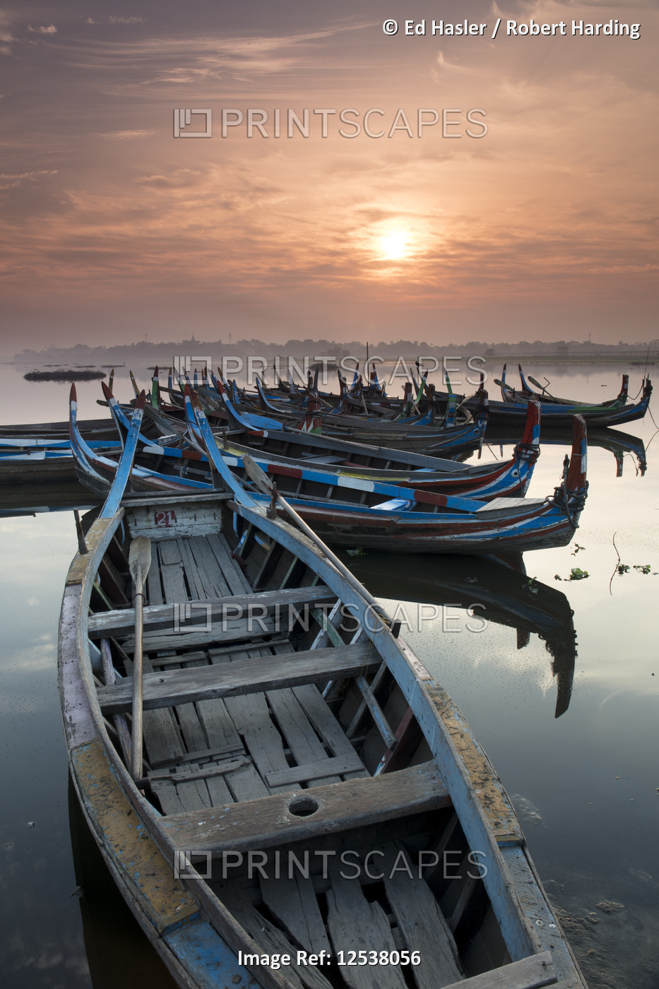 Fishing boats at sunrise on lake Taungthaman near Amarapura, Myanmar (Burma)